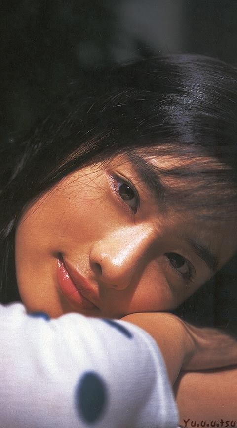 Close up portrait of a woman with long dark hair and warm lighting