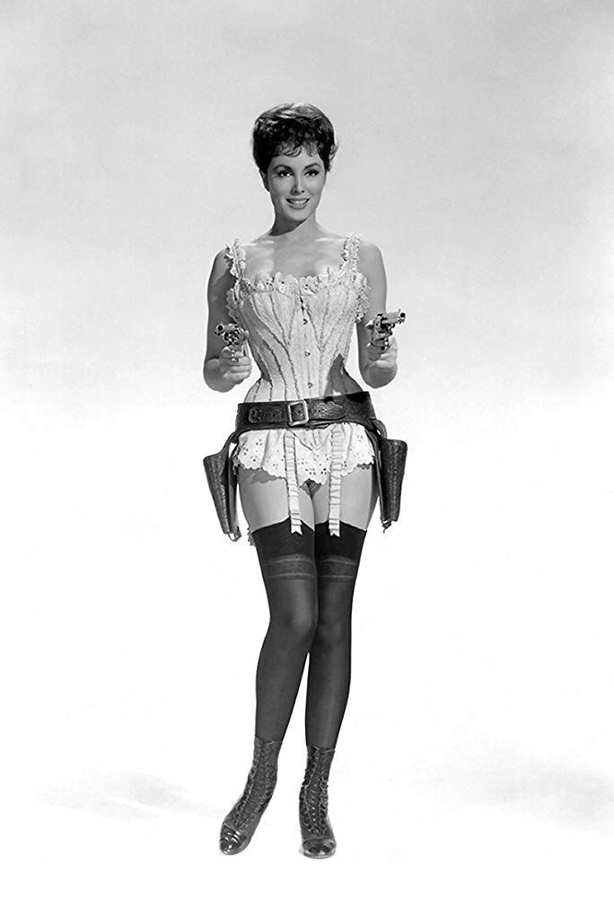 Woman in a corset, garter belt, and stockings holding two pistols