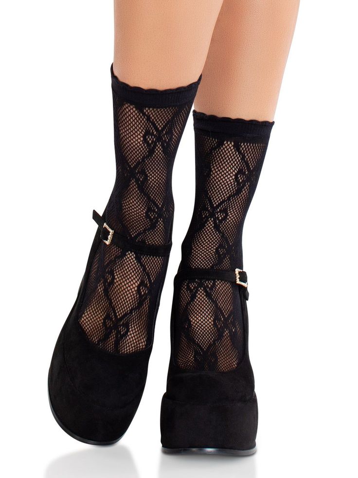 Legs wearing black fishnet socks and black mary jane platform shoes