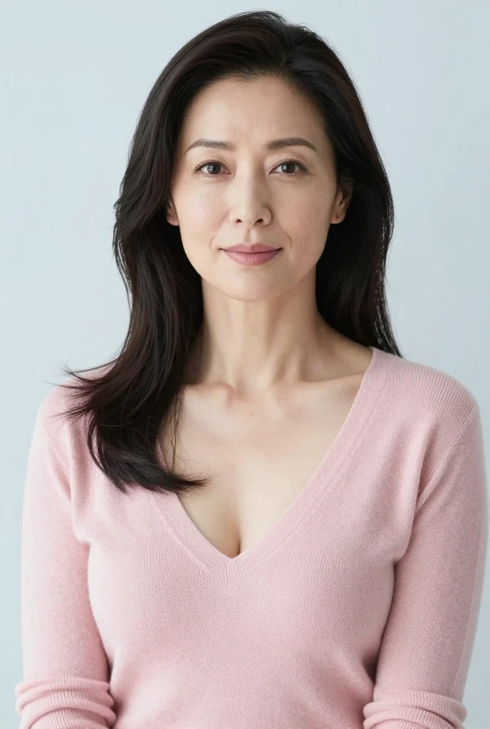 Woman with long dark hair wearing a pink v-neck sweater