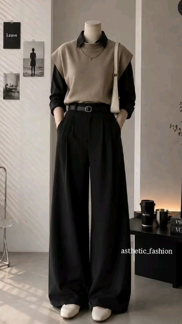 Mannequin wearing a collared shirt, sweater vest, wide leg pants, and shoulder bag
