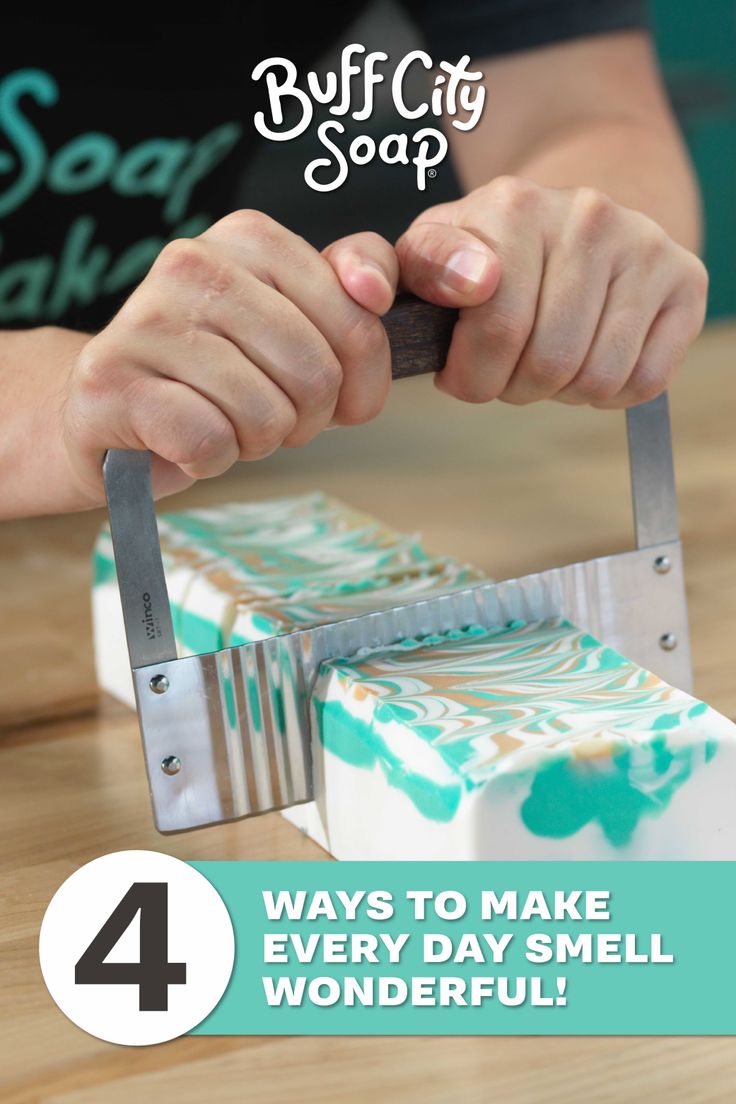 Hands cutting a block of handmade soap with a wavy cutter