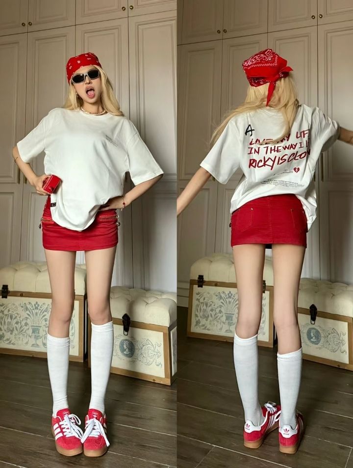 Blonde woman in a red bandana and mini skirt posing indoors