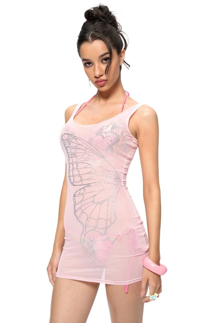Woman in a sheer pink dress with a butterfly design over a pink bikini