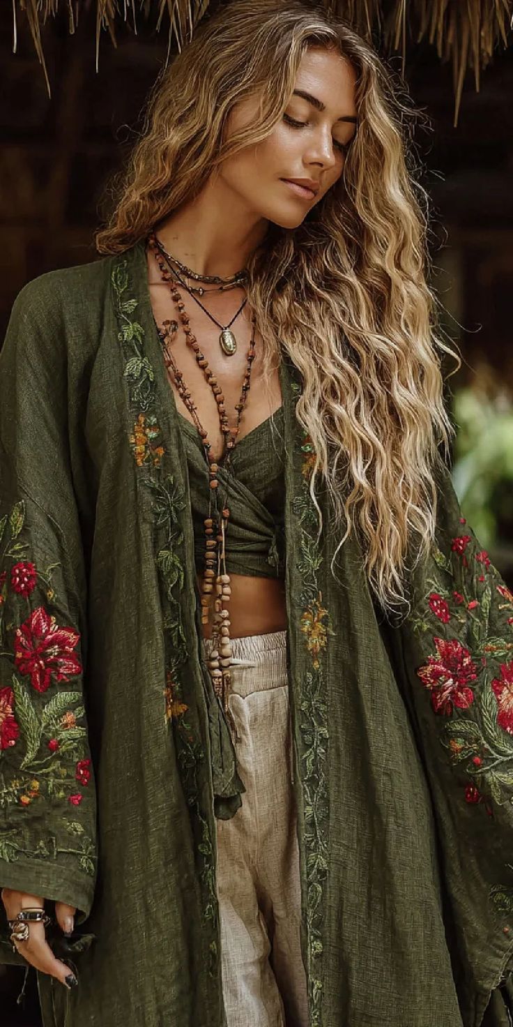 Woman with long wavy hair wearing an embroidered jacket and beaded necklaces