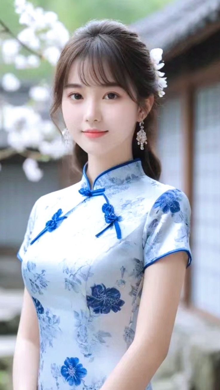 Woman in a blue floral cheongsam with white flowers in her hair