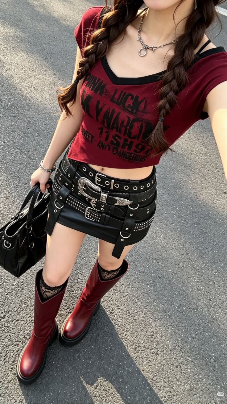 Person in a red crop top, studded mini skirt, and red boots outdoors