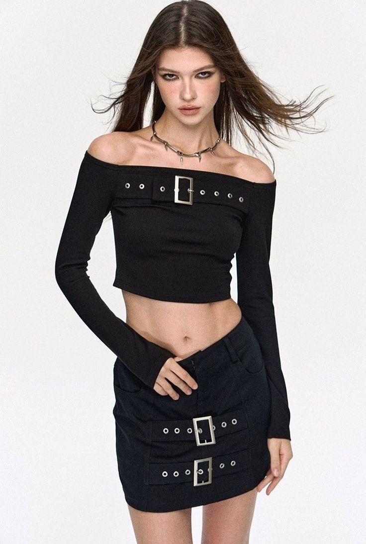Woman with long hair wearing a black off-shoulder crop top and mini skirt