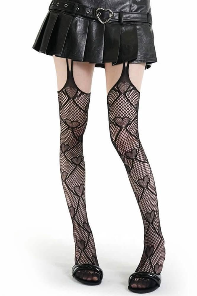 Person wearing a black pleated skirt and heart-patterned fishnet stockings