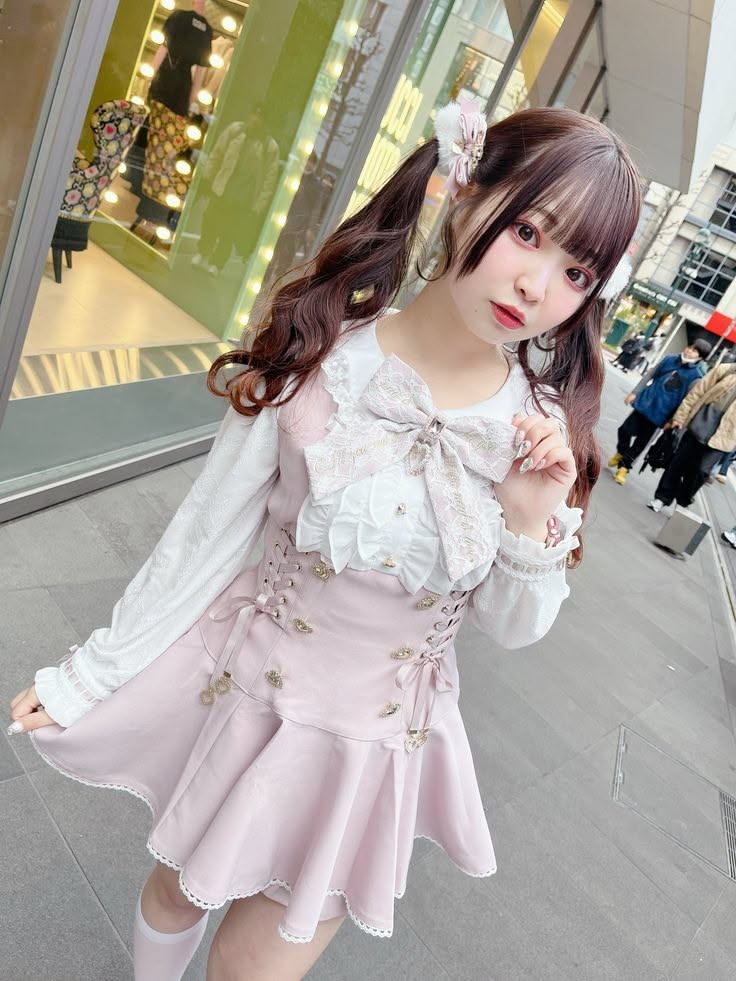 Woman in a pink dress with twin tails on a street
