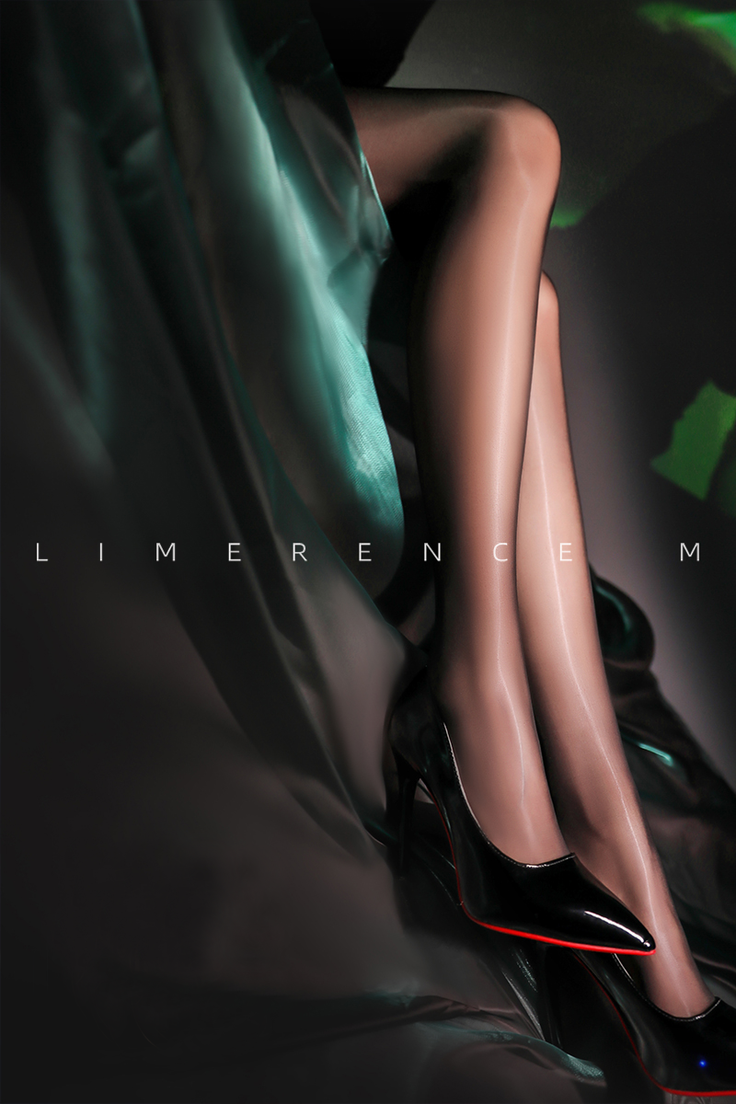 Woman's legs in black stockings and high heels with dramatic lighting
