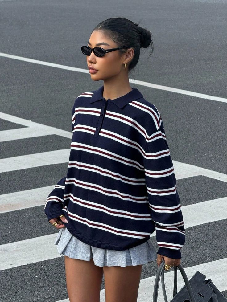 Woman in a striped polo shirt and pleated skirt on a street