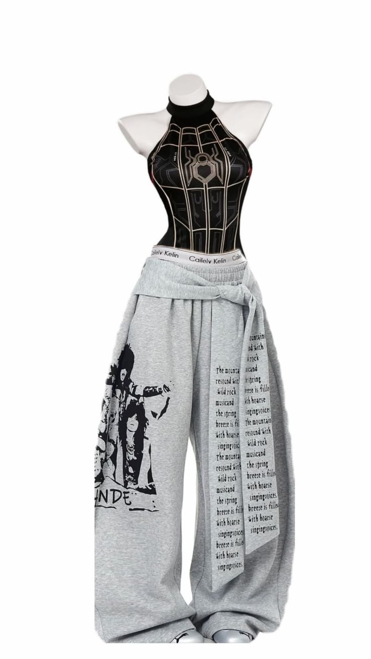 Mannequin wearing a black halter top with a spider web pattern and gray sweatpants