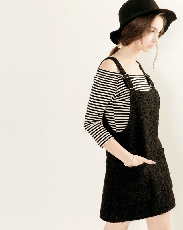 Woman in a black hat and striped shirt with a black dress