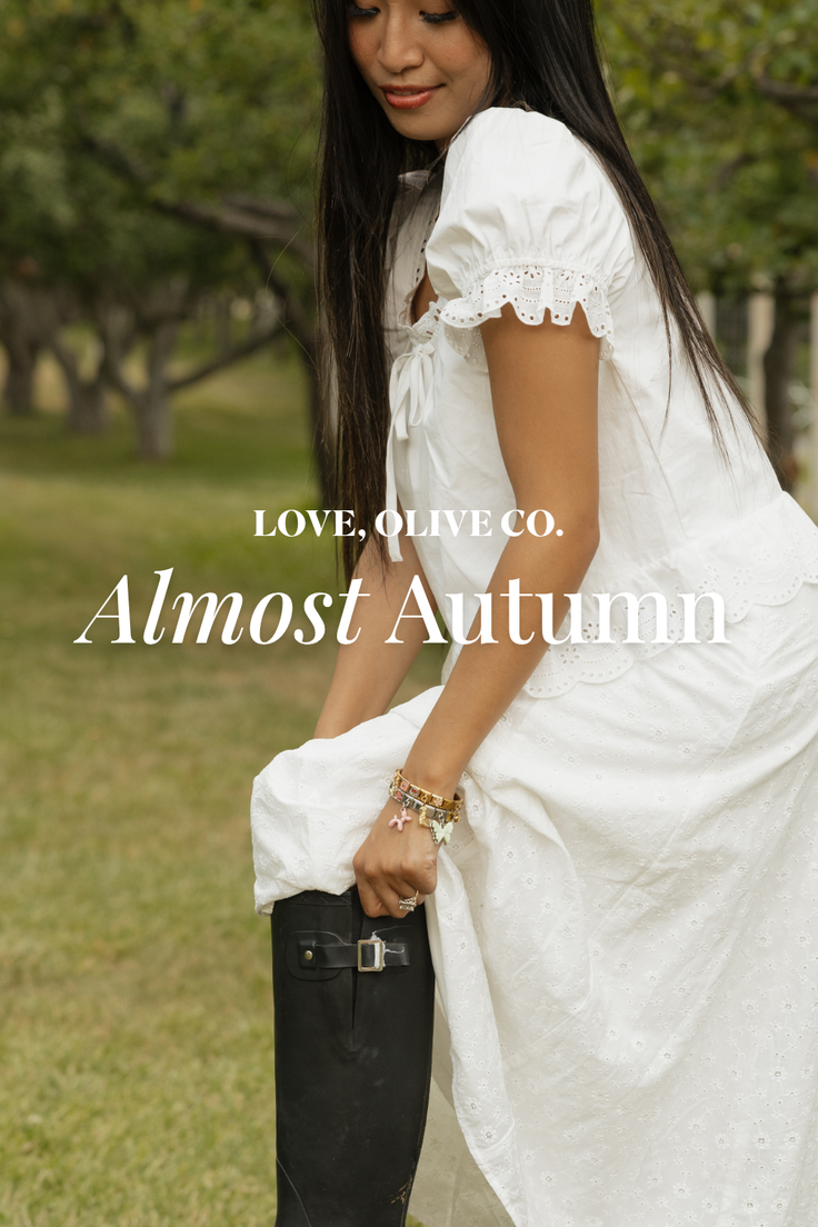 Woman in a white dress and rain boots outdoors