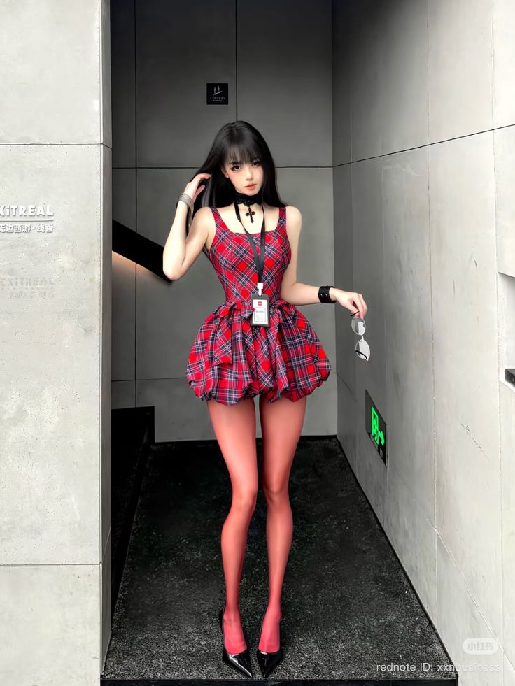 Anime style girl in a red plaid dress and red tights standing indoors