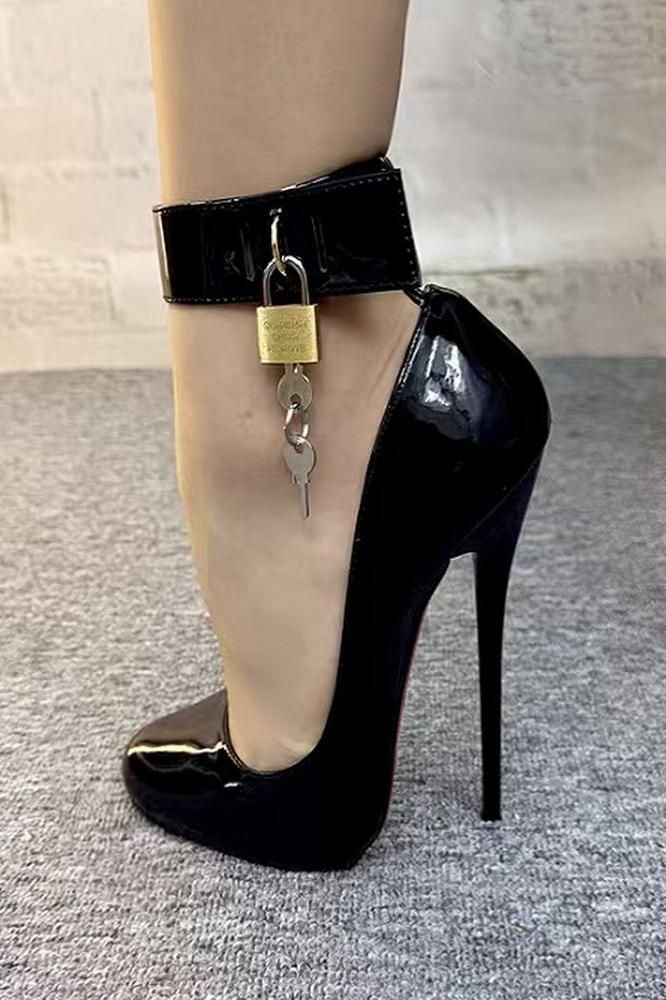 Foot in a black patent leather high heel with an ankle cuff and padlock