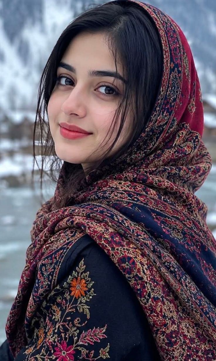 Woman in a patterned scarf and embroidered clothing outdoors in winter
