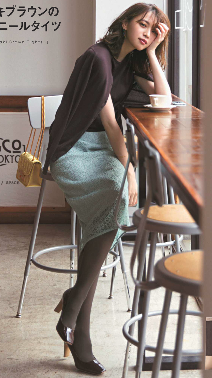 Woman with long hair wearing a lace skirt and tights in a cafe