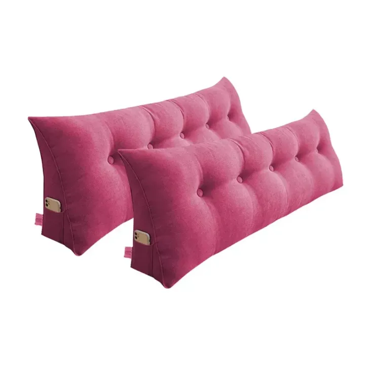 Two pink tufted wedge pillows with side pockets