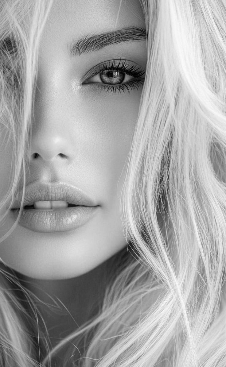 Close up black and white portrait of a woman with blonde wavy hair