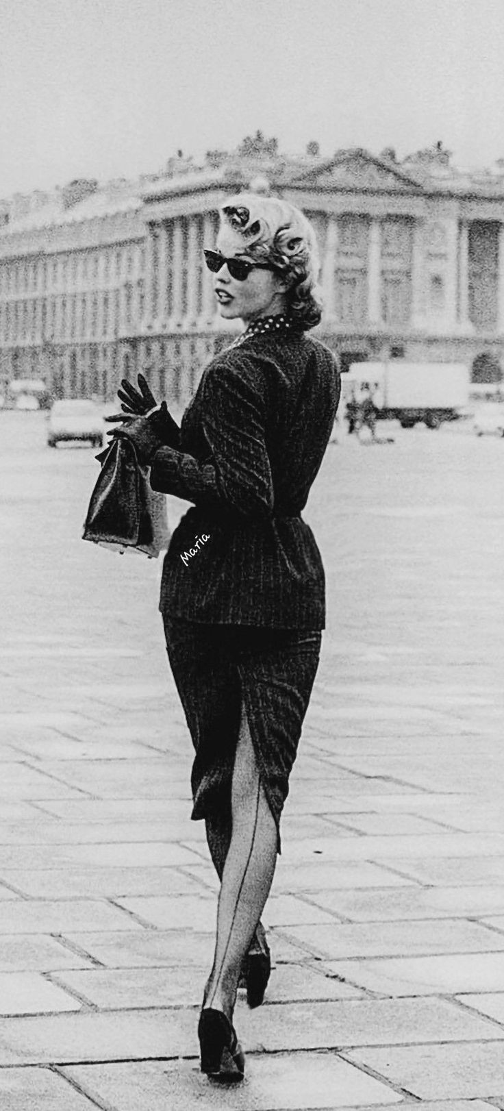 Woman in a pencil skirt and seamed stockings walking in a city
