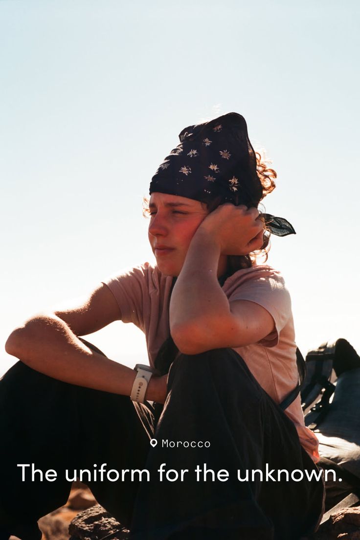 Person wearing a bandana and t-shirt outdoors in bright sunlight