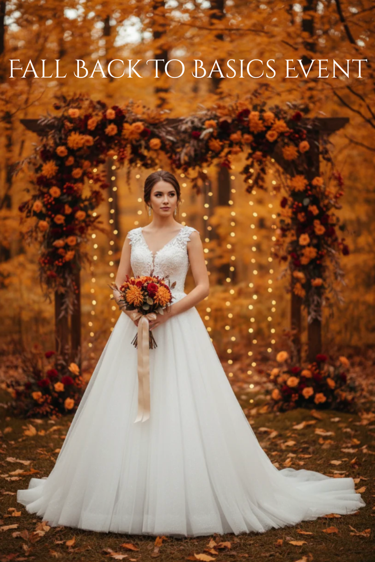 Bride in a white wedding dress holding a bouquet in an autumn outdoor setting