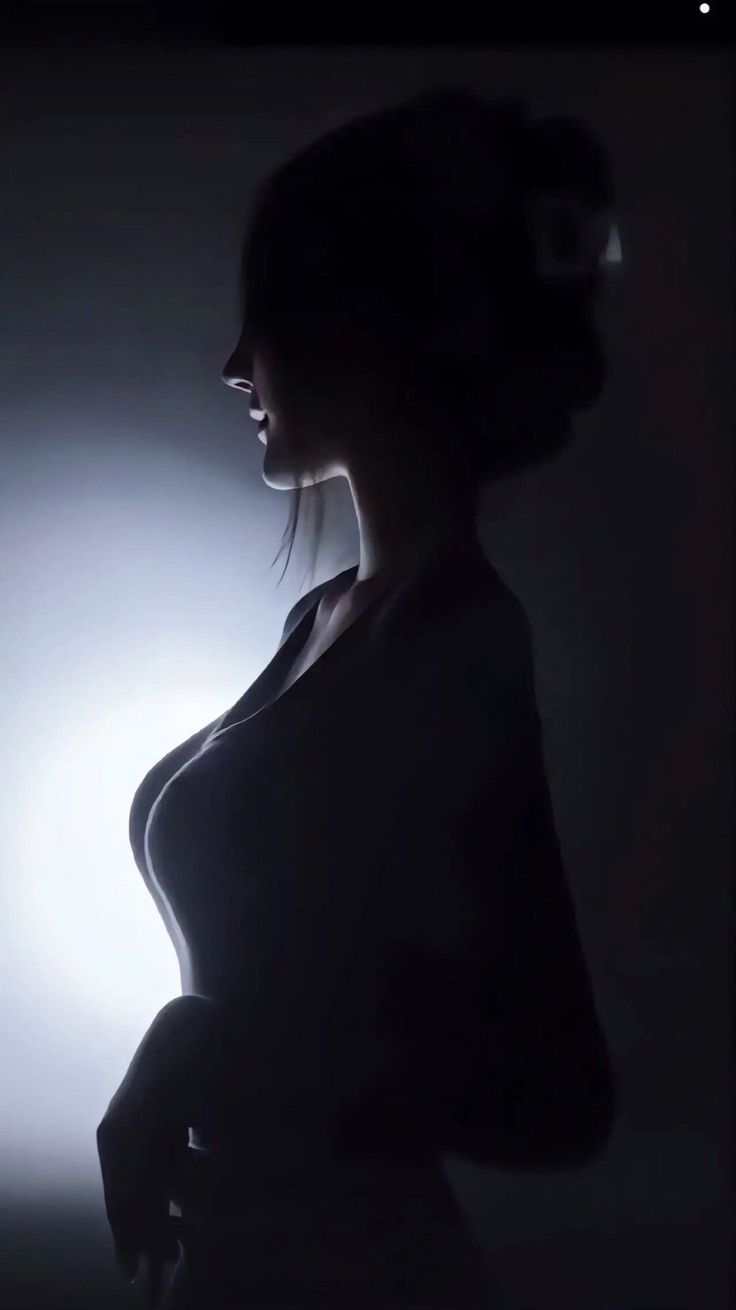 Woman in silhouette with strong backlight highlighting her profile and curves