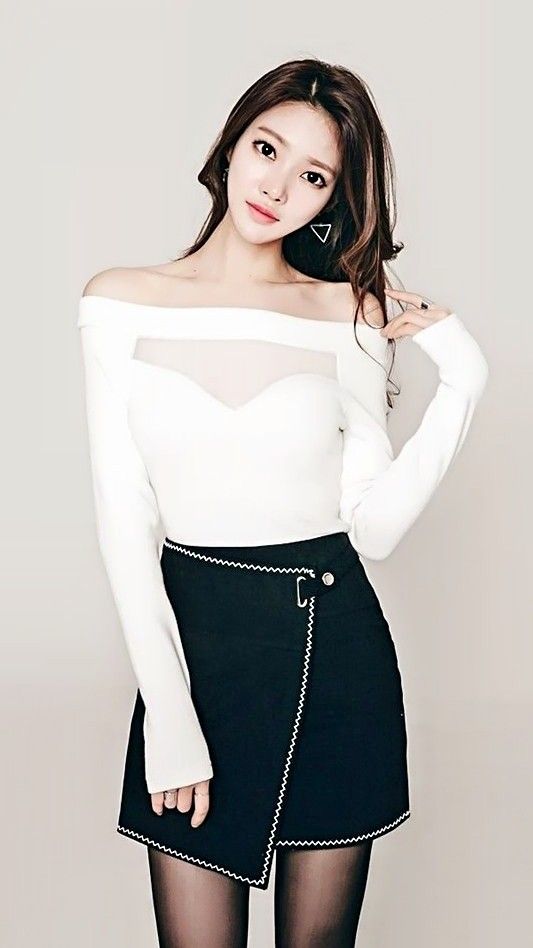 Woman in an off-shoulder top with sheer fabric and a black mini skirt