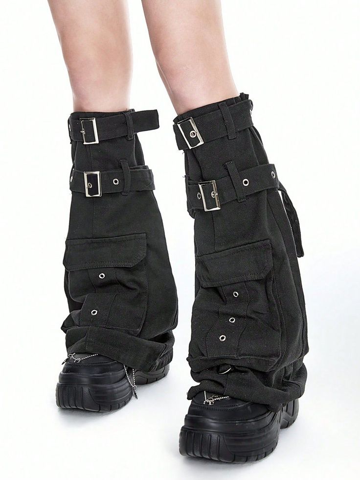 Person wearing black cargo pants with buckles and platform shoes