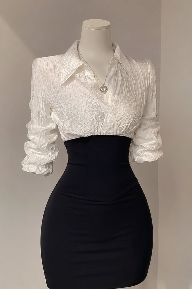 Mannequin wearing a white textured shirt and a black high-waisted skirt
