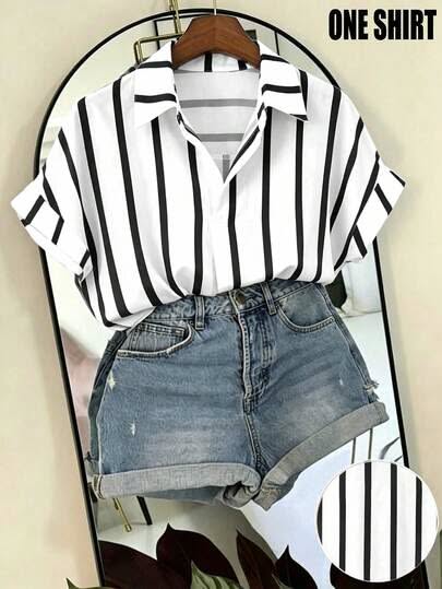 White and black striped shirt with denim shorts on a hanger in front of a mirror