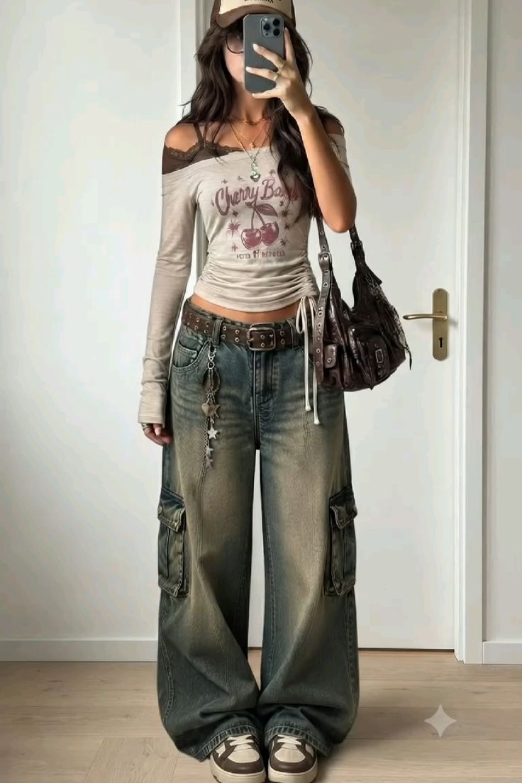 Person in cargo jeans and an off-shoulder top taking a mirror selfie