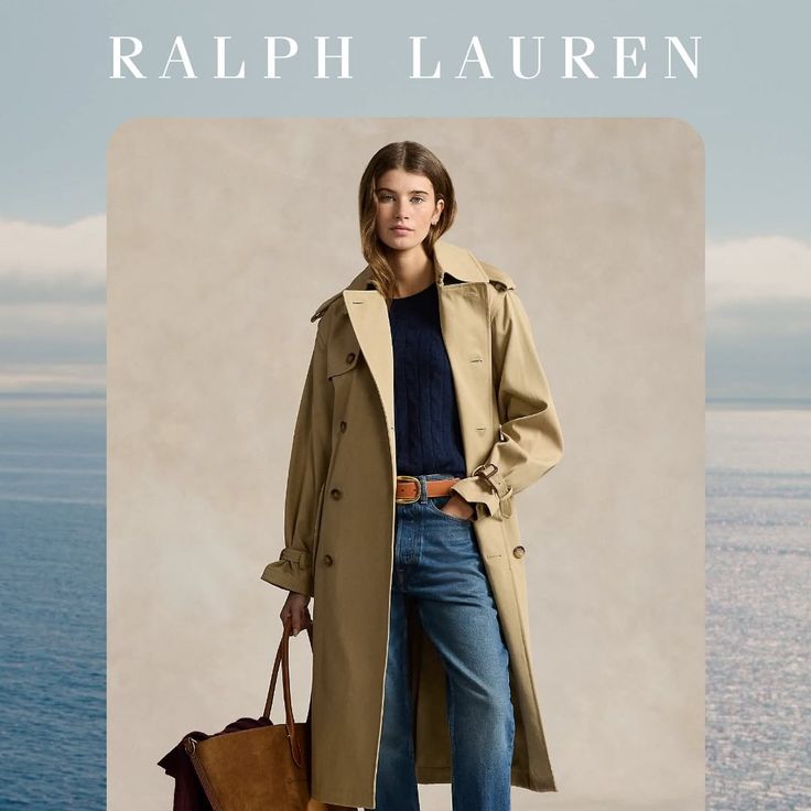 Woman in a trench coat and jeans holding a bag outdoors