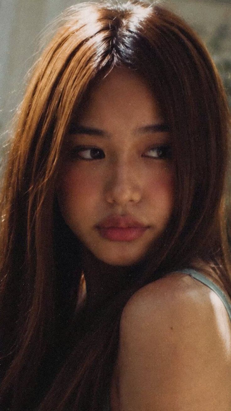 Woman with long brown hair and soft lighting on her face