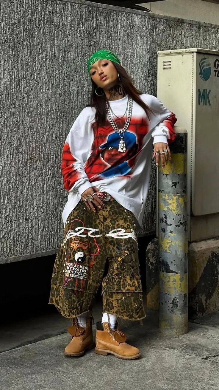 Woman in a green bandana and oversized shirt with leopard print pants outdoors