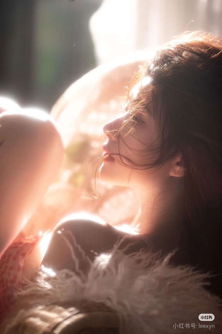 Woman with long hair in soft backlight with warm tones