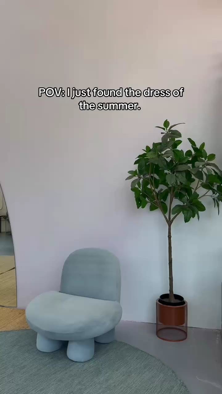 Modern chair and potted plant in a minimalist indoor setting