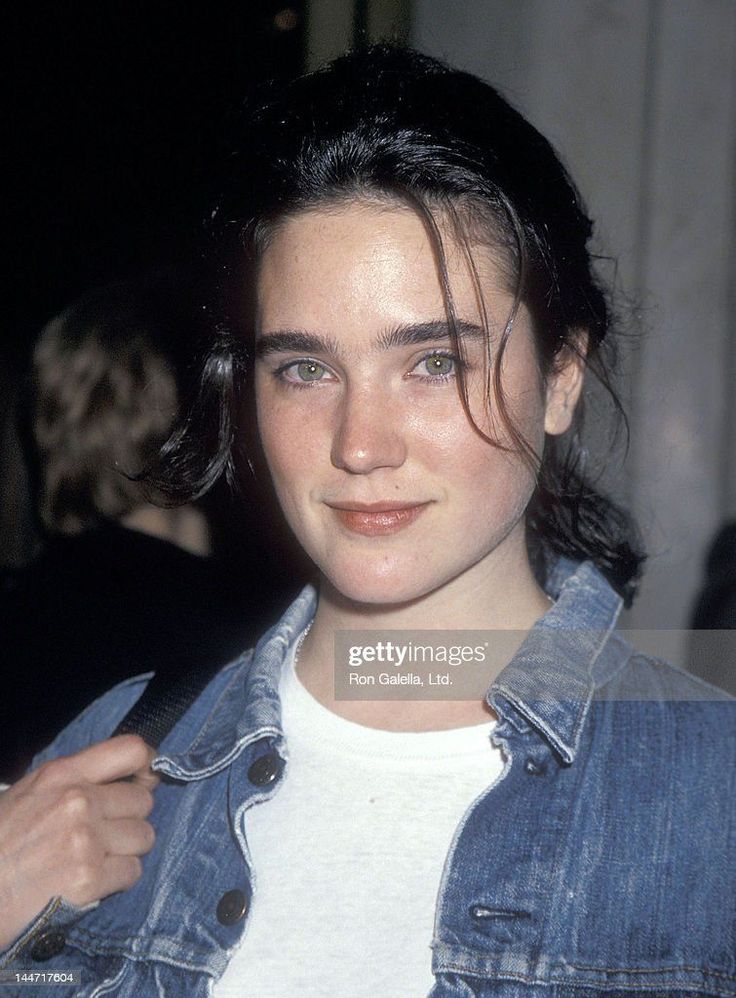 Woman with black hair and green eyes wearing a denim jacket