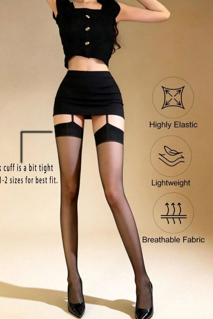 Woman in a black crop top, mini skirt, and stockings posing in a studio