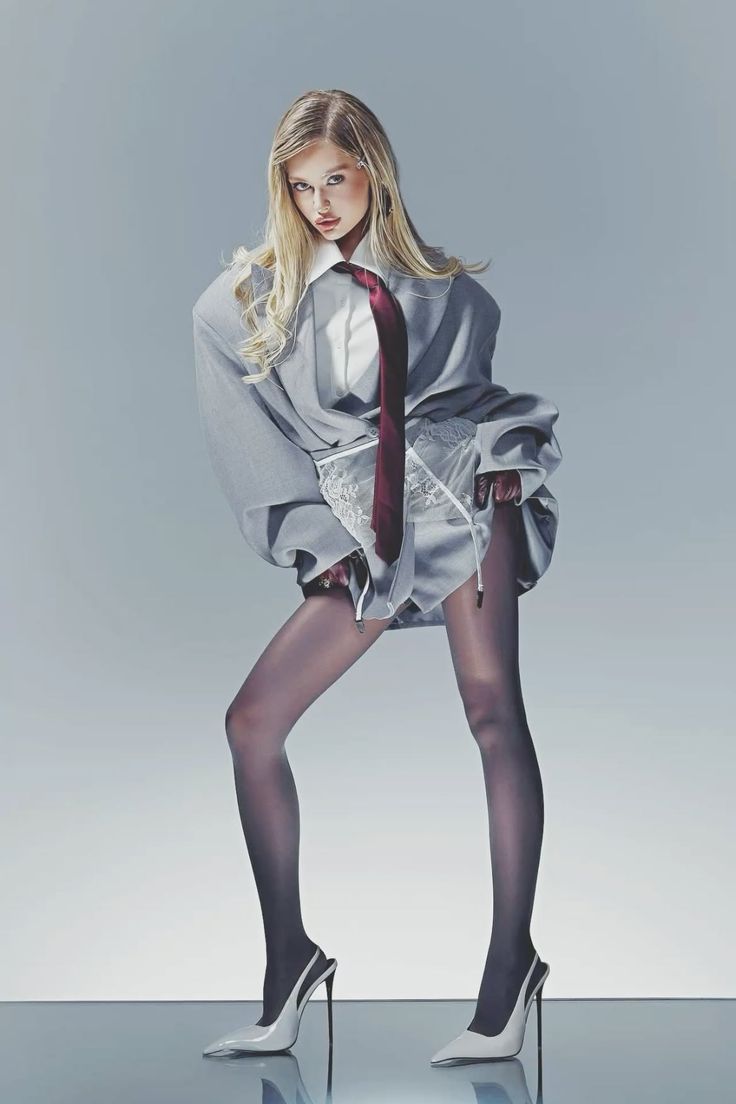 Blonde woman in an oversized shirt, red tie, and lace lingerie with black pantyhose