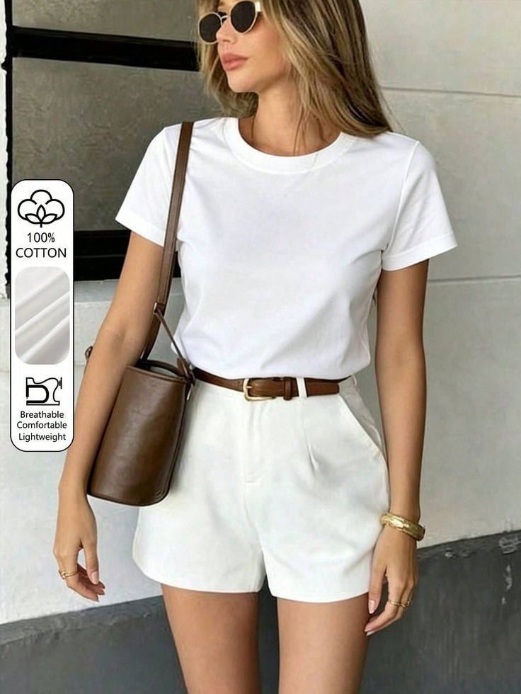 Woman in a white t-shirt and white shorts with a brown belt and sunglasses