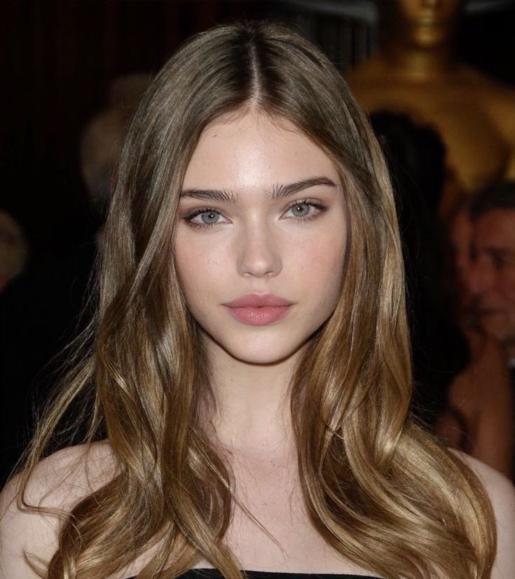 Woman with long wavy hair and blue eyes in a portrait shot