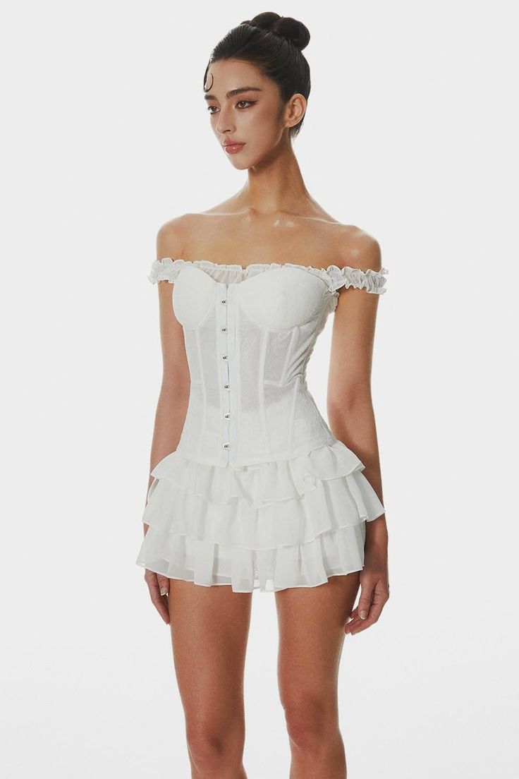 Woman in a white off-shoulder corset dress with a ruffle skirt