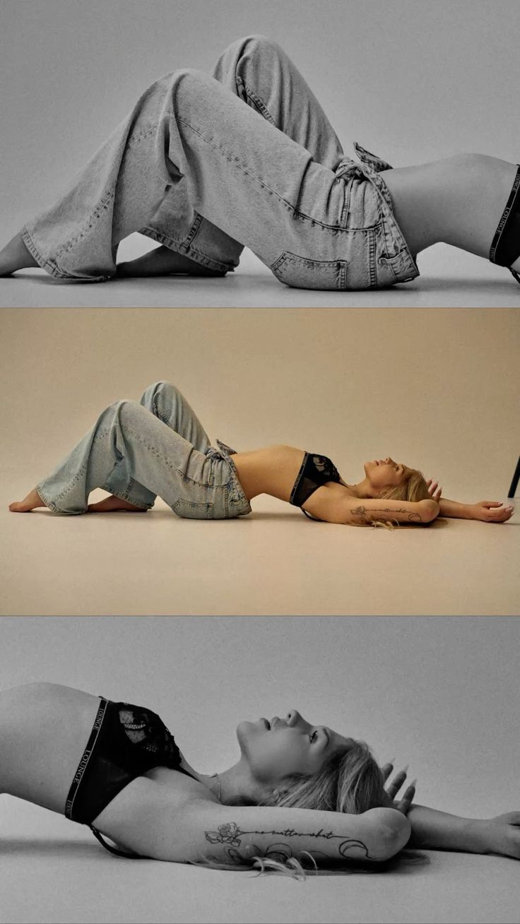 Woman in jeans and a black bra lying on her back in a studio