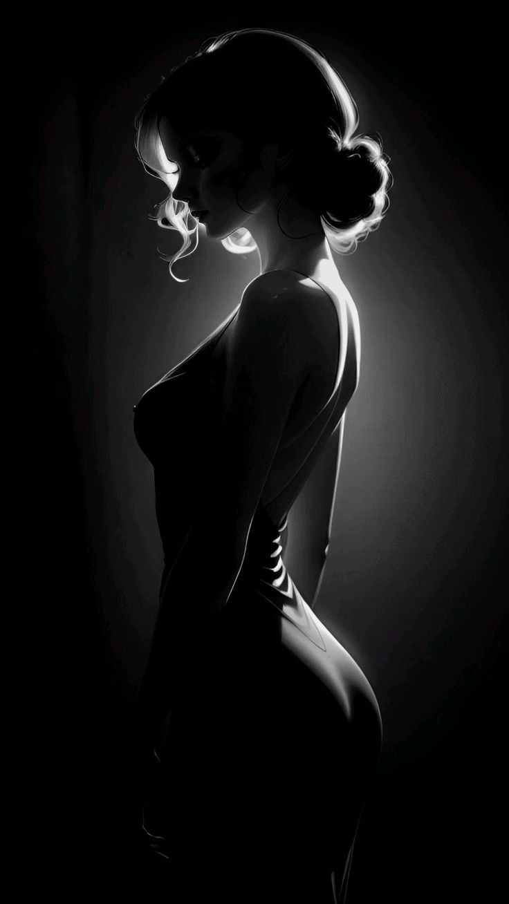 Woman in a dress with an updo, dramatically backlit in a dark setting