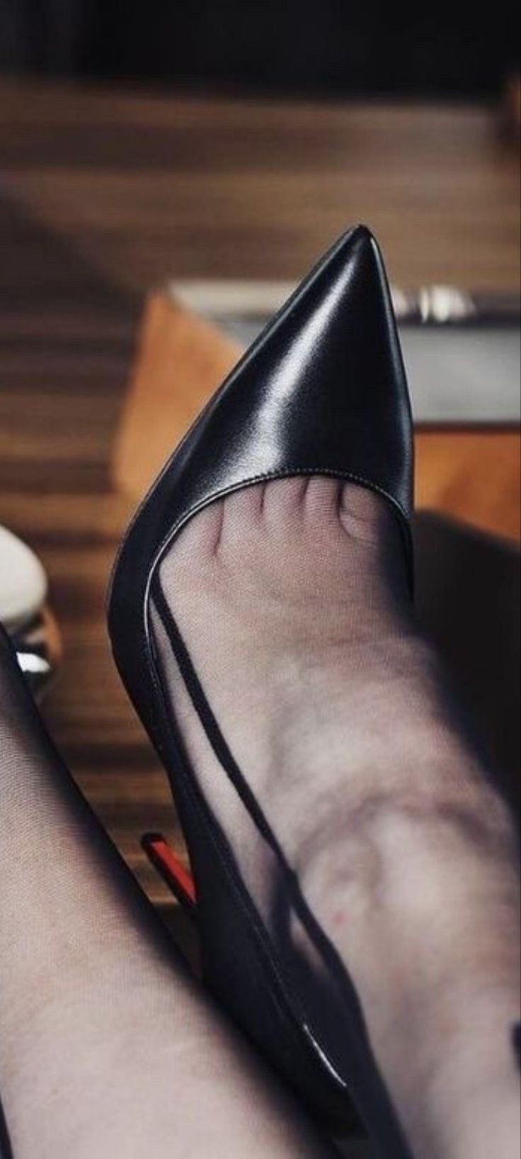 Close up of a foot in a black high heel and stocking