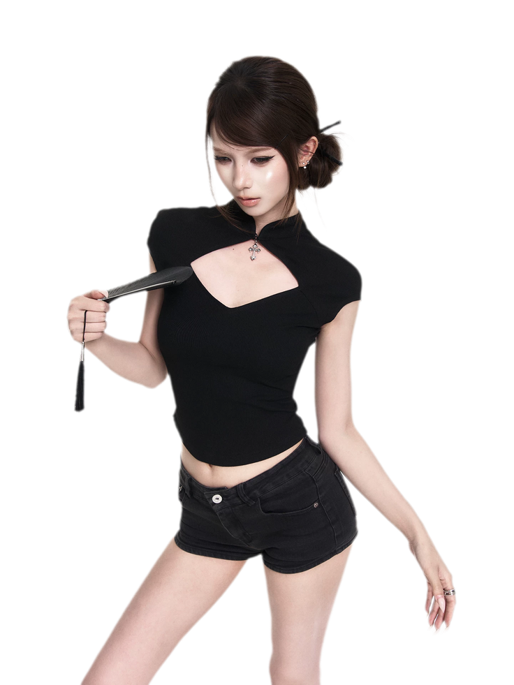 Woman in a black top and shorts holding a fan