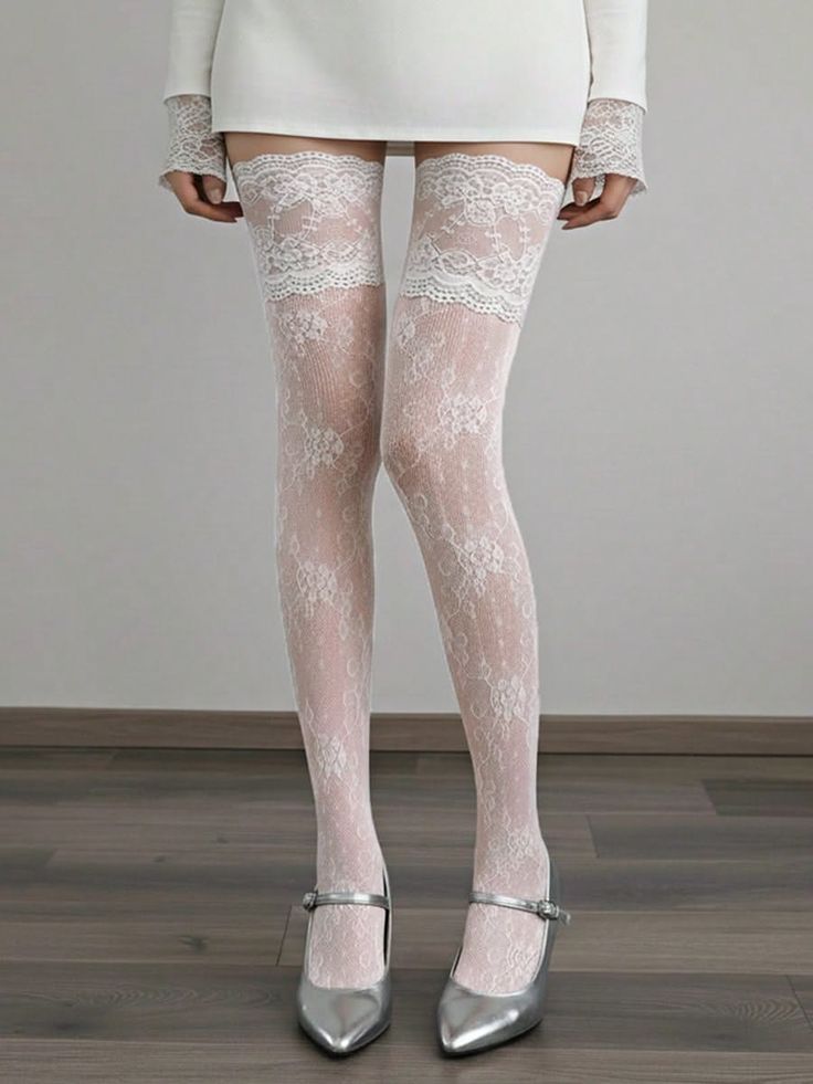 Woman wearing white lace stockings and silver heels with a short dress